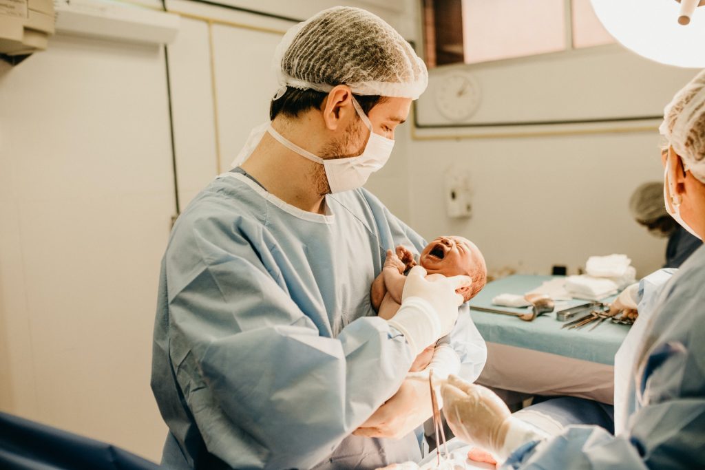 Man holding newborn baby